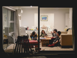 A group of college students relaxes in their rented home