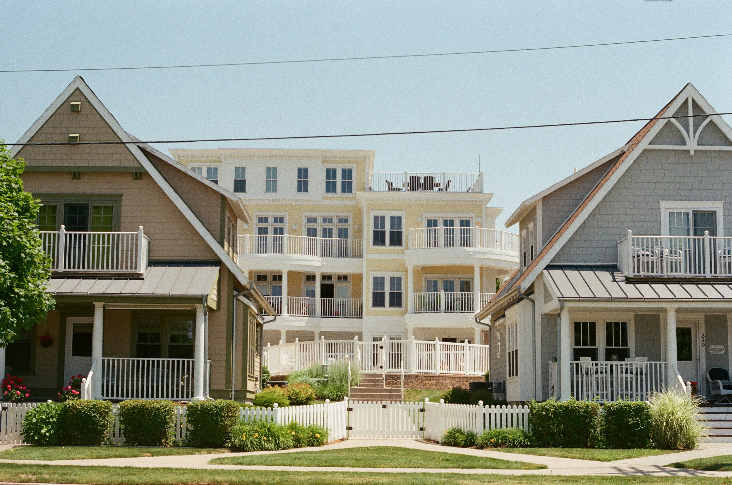 Two houses with similar architecture are next to each other