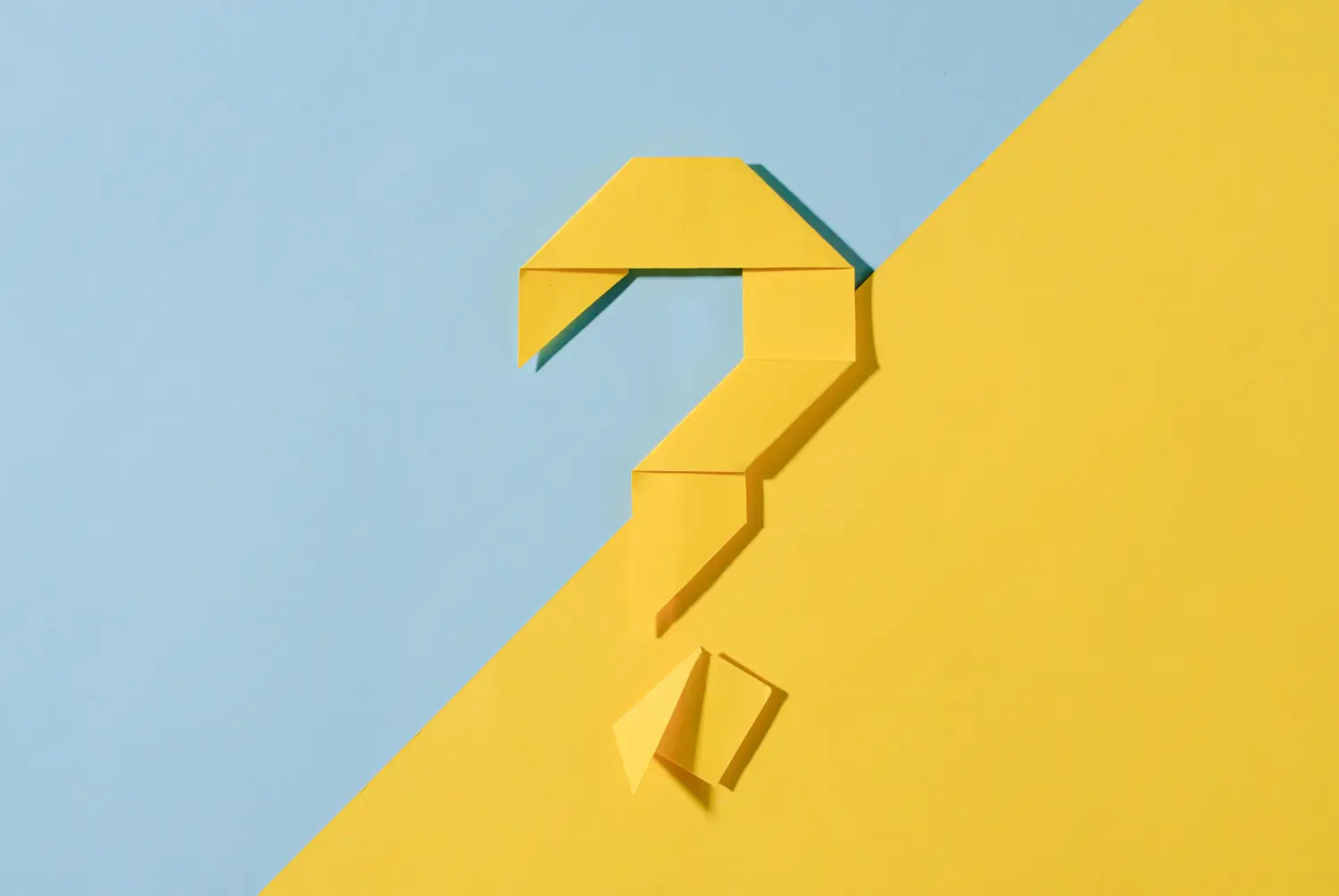 A yellow origami question mark on a diagonal two-tone background in yellow and light blue