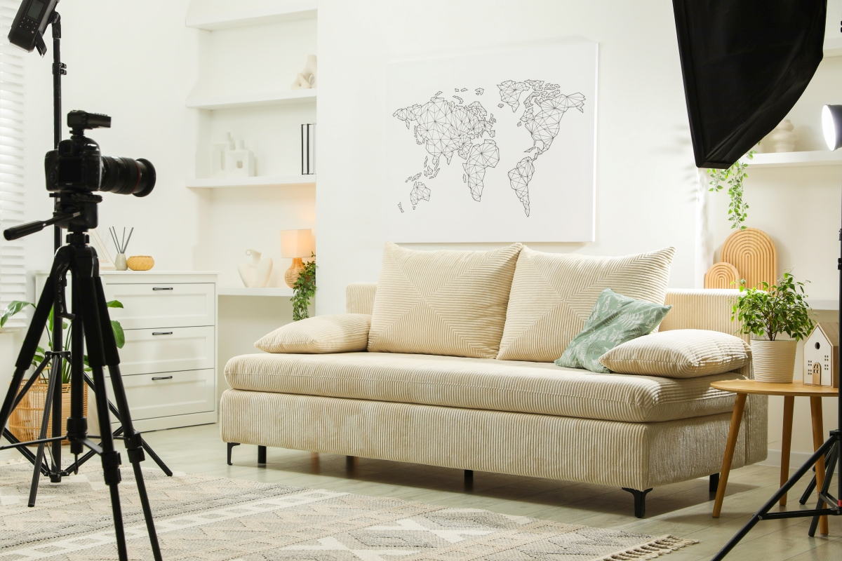 A staged living room area being photographed with professional lighting and equipment