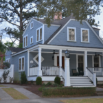 A two-story house with a large front porch and white columns