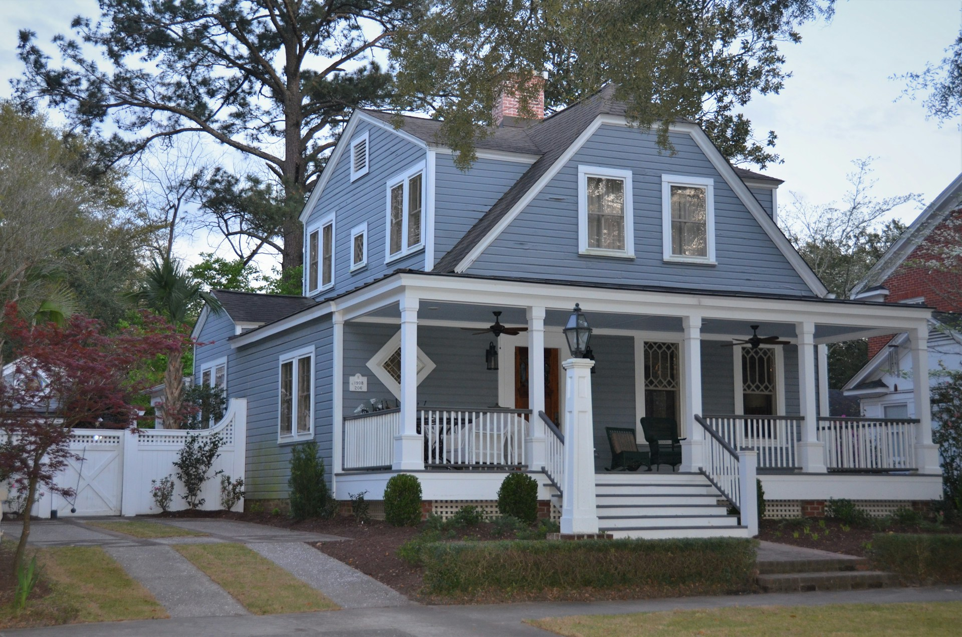 A two-story house with a large front porch and white columns