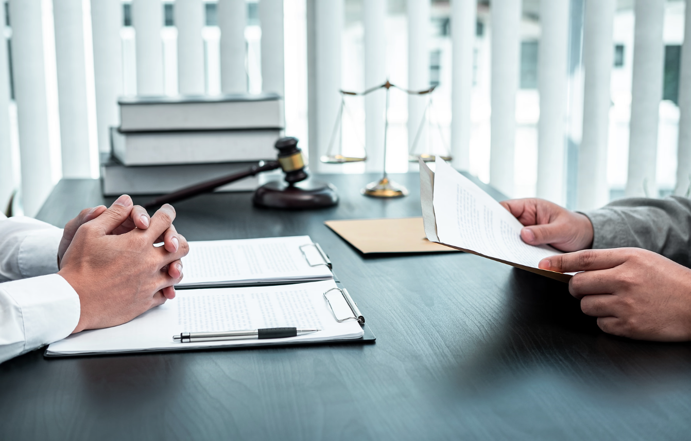 A lawyer reviews legal documents with a client